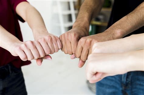 Close-up of people's hands making fist bump Photo | Free ...